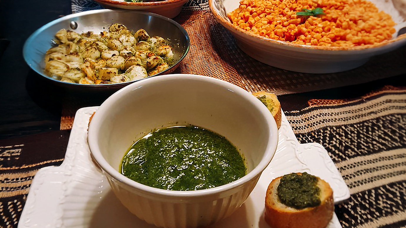 A spread of food featuring pesto marinated scallops.