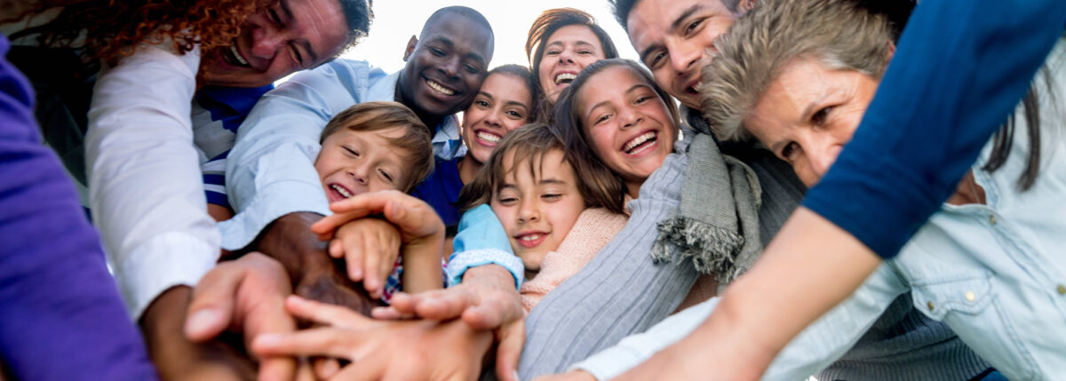 People smiling and placing hands together