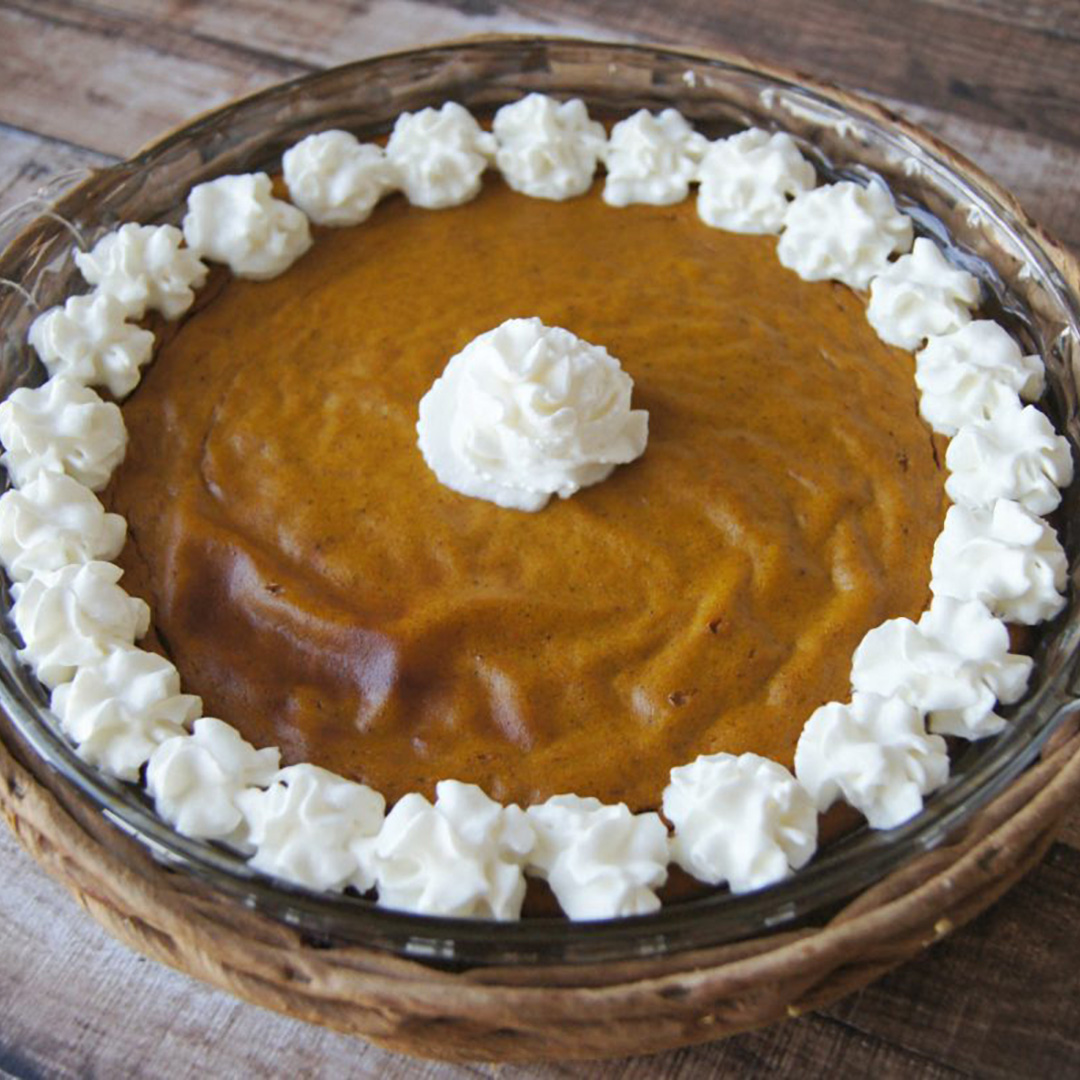Low-carb, crustless pumpkin pie topped with whipped cream.