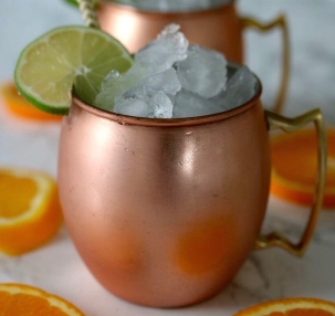 A Moscow mule packed with ice and garnished with lime.