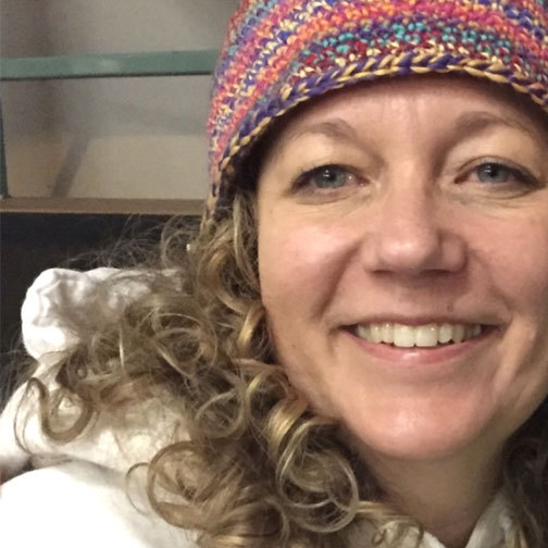 Alicia Meader wears a beanie and smiles.