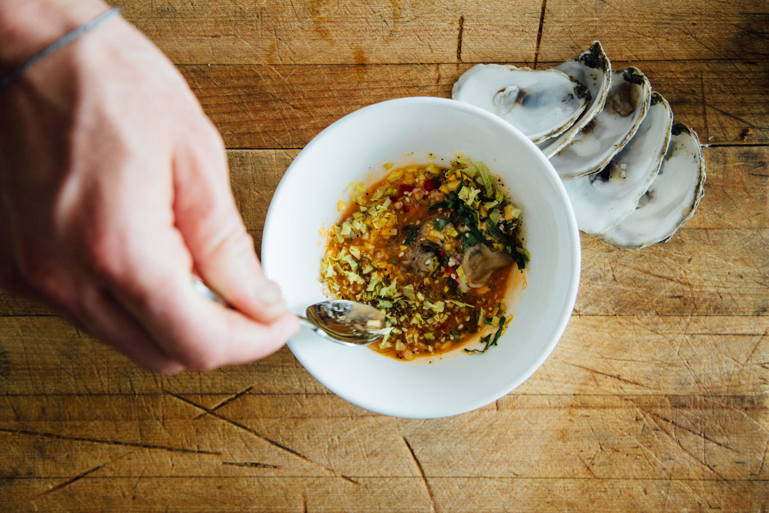 Sam's hand preparing dish