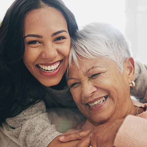 Mother and daughter smiling