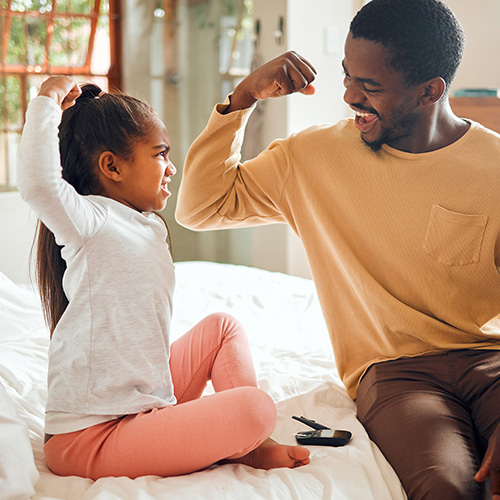 Father and daughter flexing together