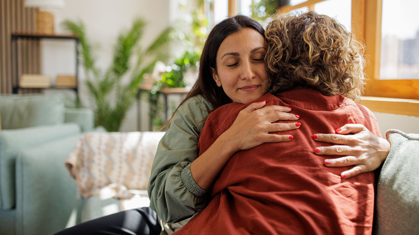 Two people embrace in a hug.