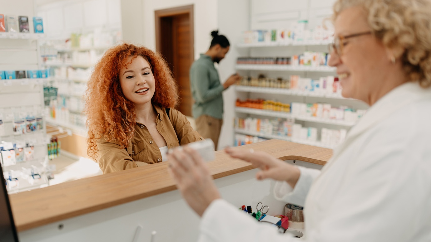 Woman checks out at the pharmacy counter.