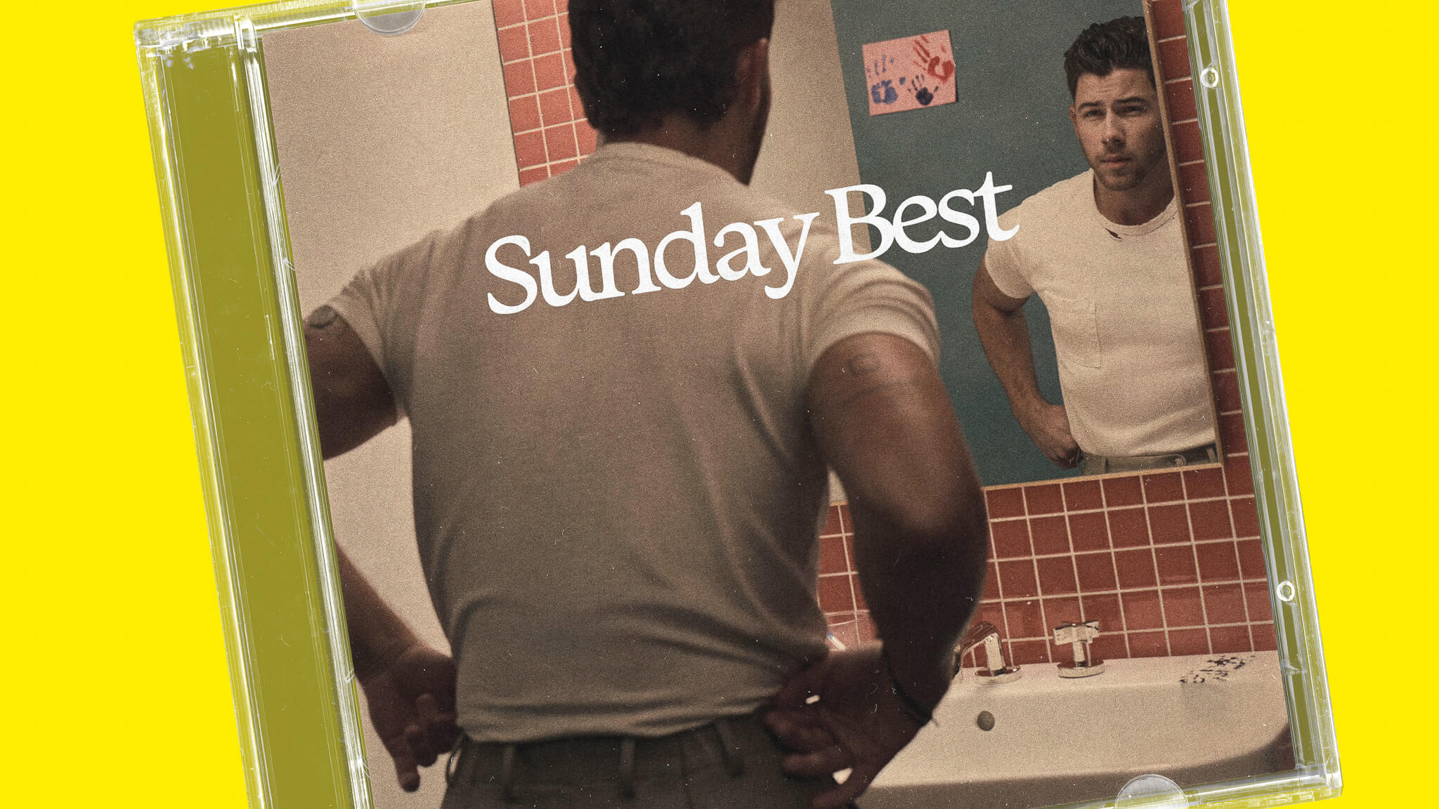 Nick Jones poses in mirror wearing a CGM.