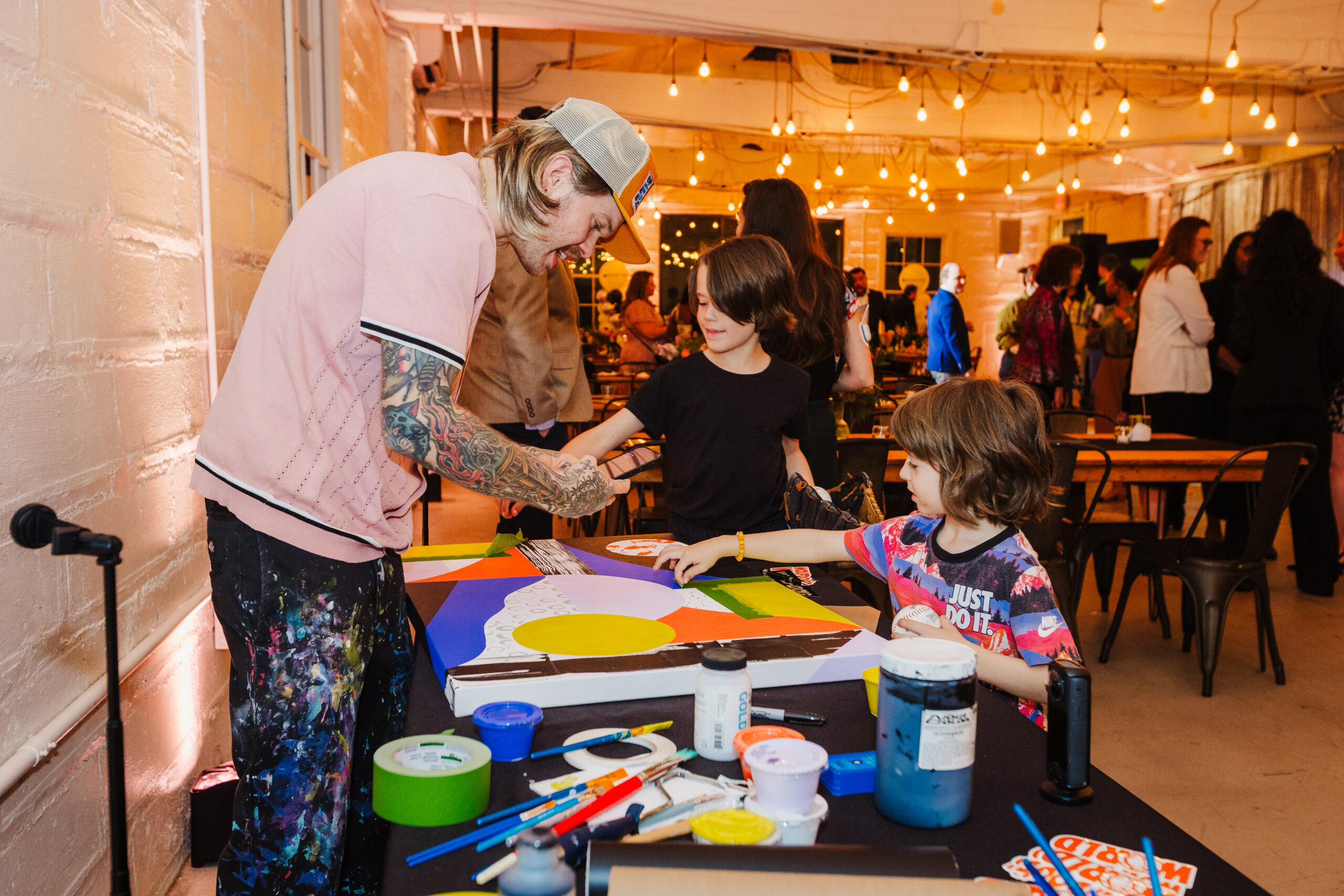artist speaking to child at event