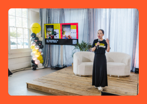 Woman on stage giving presentation
