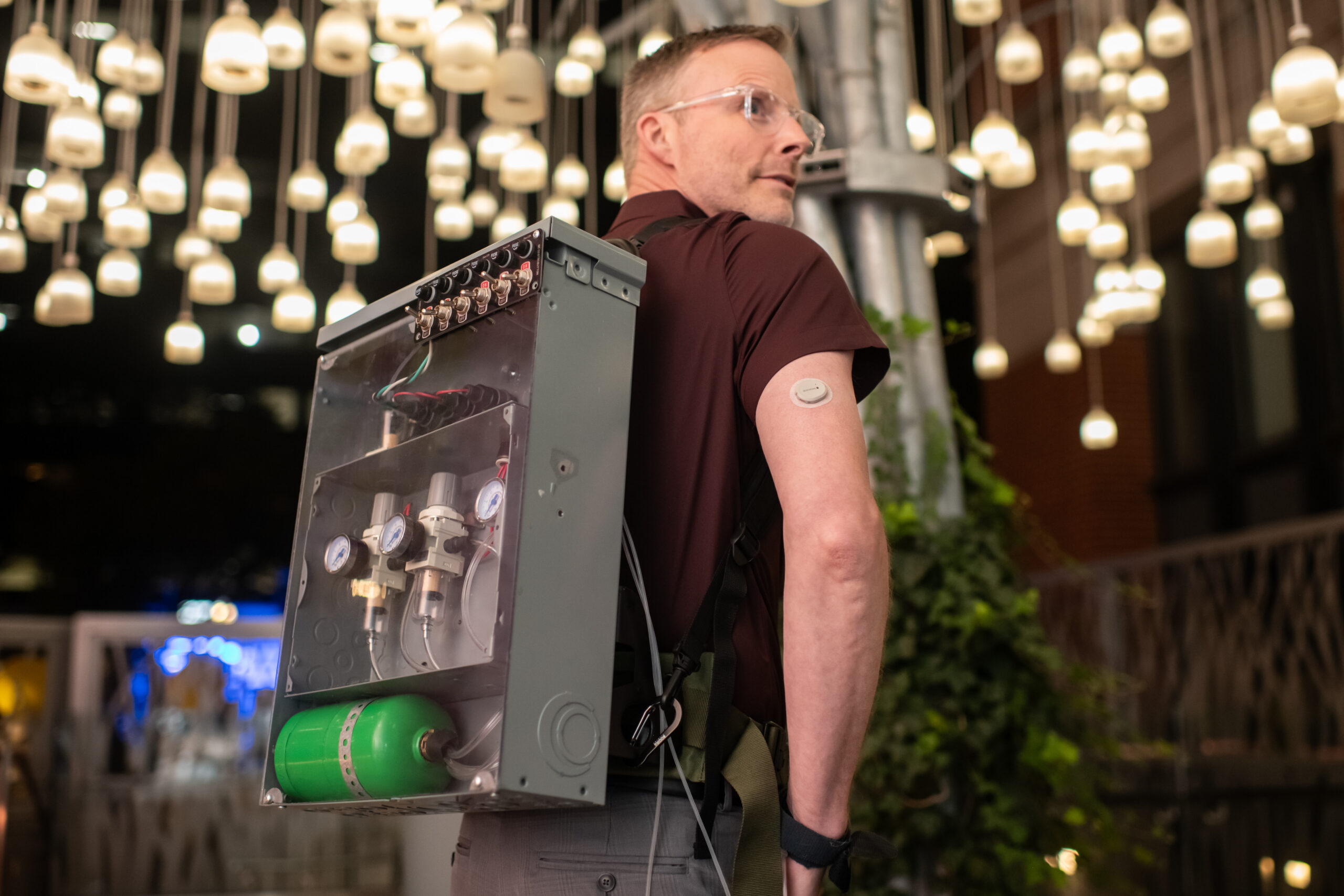 man wearing insulin backpack prop